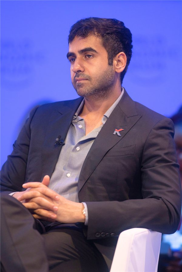 Nikhil Kamath in a dark suit on a panel at the World Economic Forum